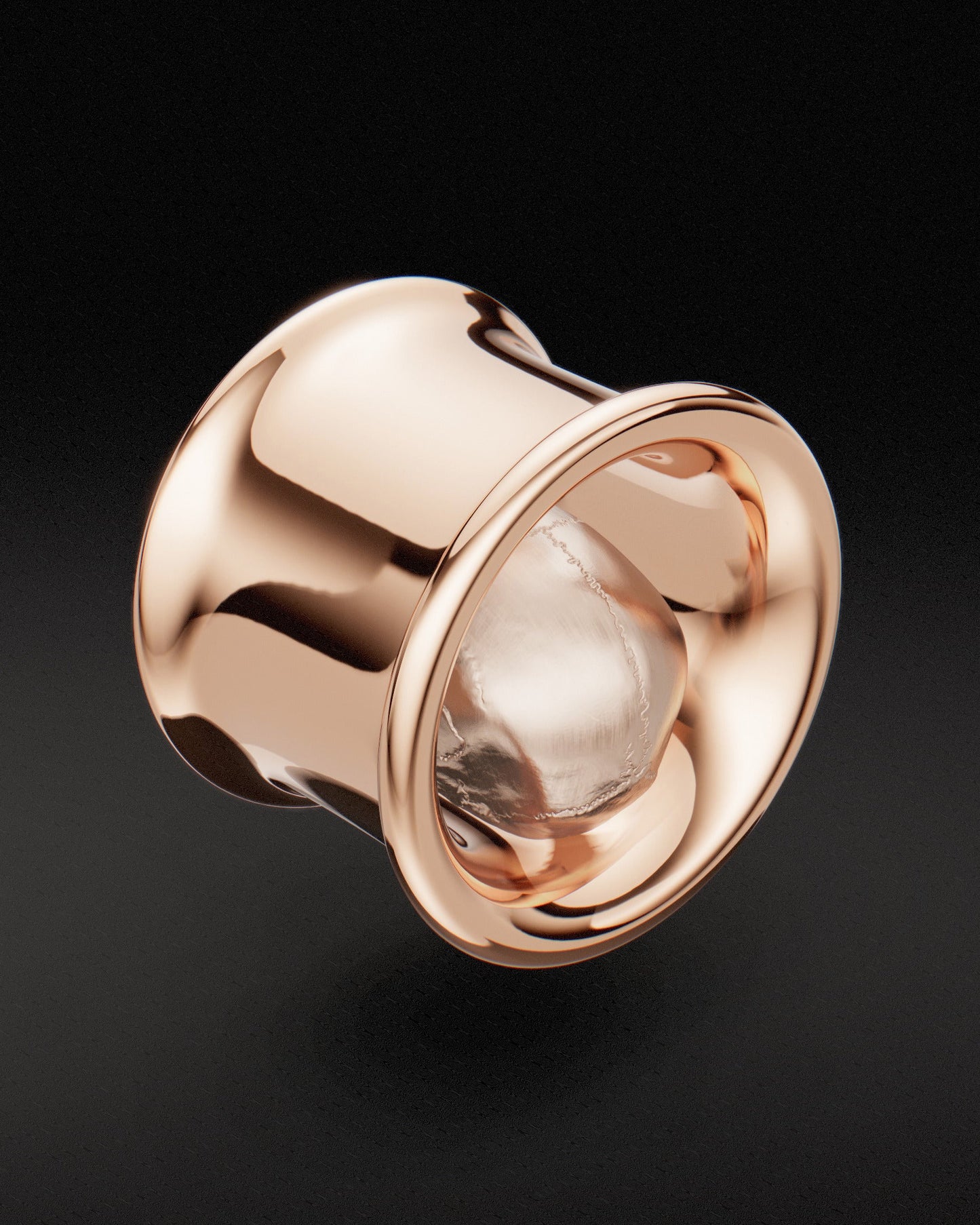 Rear three-quarter view of a rose gold memento mori skull ear tunnel with sculpted skull detail