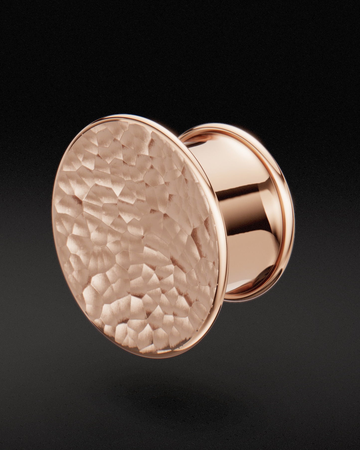 Rose gold Mayan flare ear tunnel with concave hammered face, three-quarter view