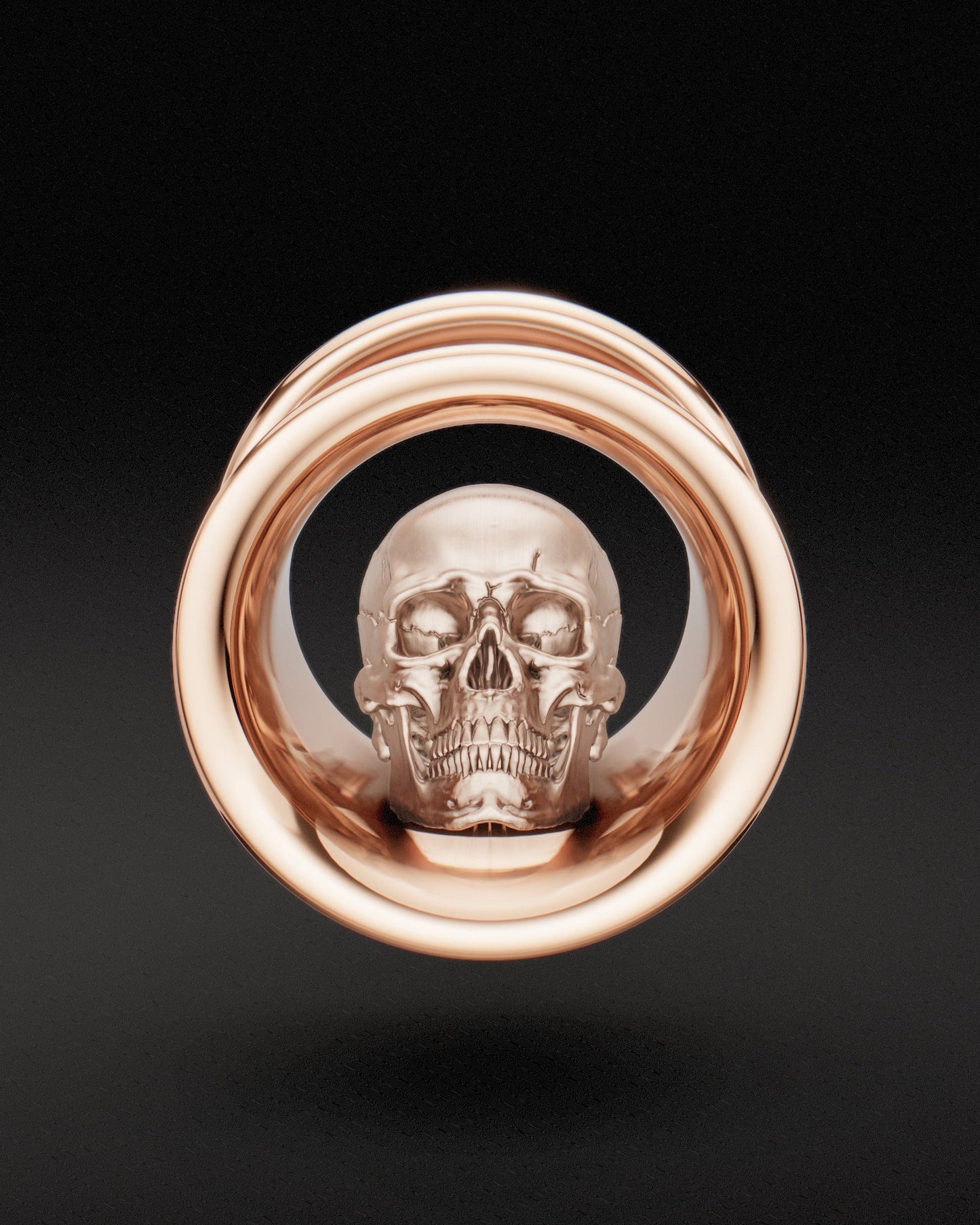 Front view of Memento mori ear tunnel with sculpted skull detail in rose gold